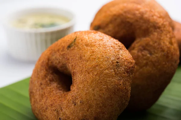 south indian food called vada sambar or sambar vada or wada, served with coconut, green and red chutney and south indian style hot coffee, selective focus