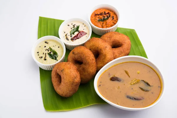 south indian food called vada sambar or sambar vada or wada, served with coconut, green and red chutney and south indian style hot coffee, selective focus