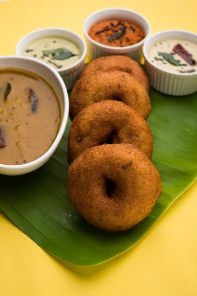 south indian food called vada sambar or sambar vada or wada, served with coconut, green and red chutney and south indian style hot coffee, selective focus