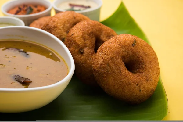 south indian food called vada sambar or sambar vada or wada, served with coconut, green and red chutney and south indian style hot coffee, selective focus