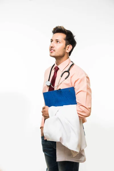 Portrait of an cheerful Indian handsome male doctor with a stethoscope around his neck, isolated over white background, selective focus — Stock Photo, Image