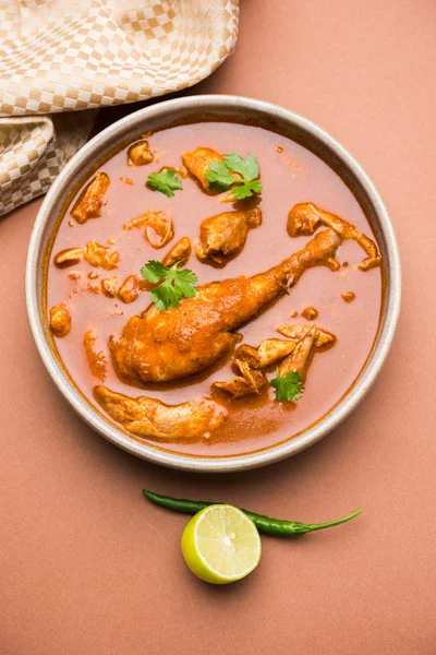 Indian spicy Chicken curry or masala chicken with prominent leg piece, popular recipe from India, selective focus — Stock Photo, Image