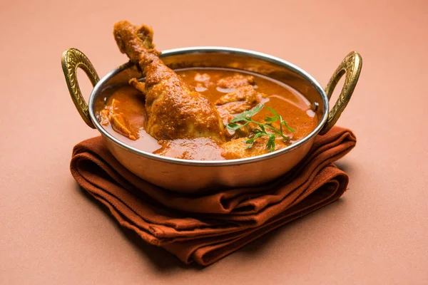 Indian spicy Chicken curry or masala chicken with prominent leg piece, popular recipe from India, selective focus — Stock Photo, Image