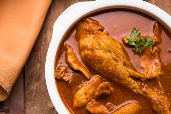 Indian spicy Chicken curry or masala chicken with prominent leg piece, popular recipe from India, selective focus