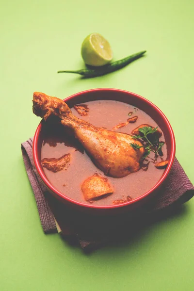 Indian spicy Chicken curry or masala chicken with prominent leg piece, popular recipe from India, selective focus — Stock Photo, Image