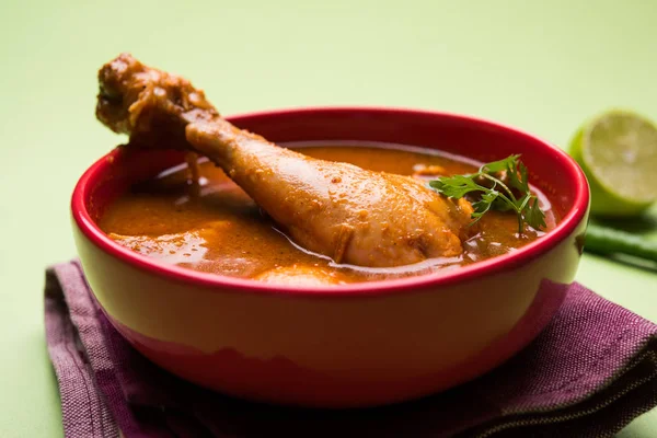 Indian spicy Chicken curry or masala chicken with prominent leg piece, popular recipe from India, selective focus