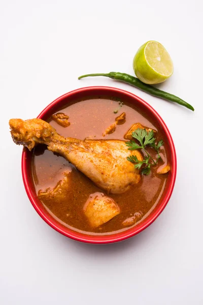 Indian spicy Chicken curry or masala chicken with prominent leg piece, popular recipe from India, selective focus