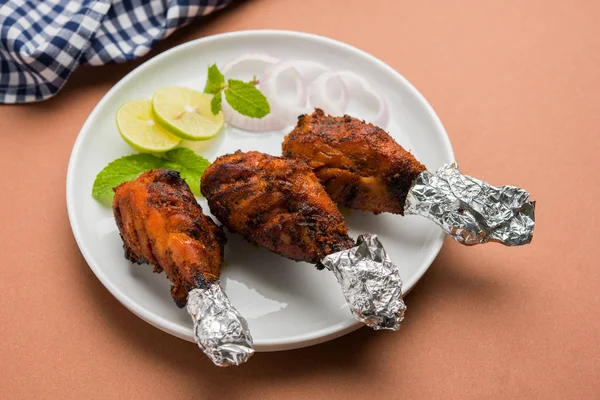 Chicken Tangri kabab or kebab - three Chicken leg pieces marinated with red sauce then grilled and served with salad. It can be served with green chutney — Stock Photo, Image