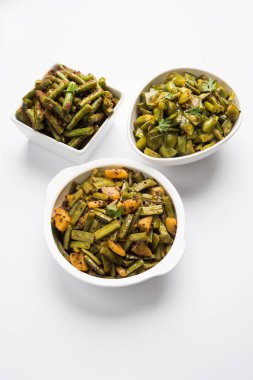 Portre resim Hint yeşil sebze masala sosu / sabzi / sabji gibi yeşil fasulye, gowar /cluster beans ve bhindi ya da bayanlar parmak ya da bamya. Beyaz arka plan üzerinde beyaz seramik kase hizmet. 