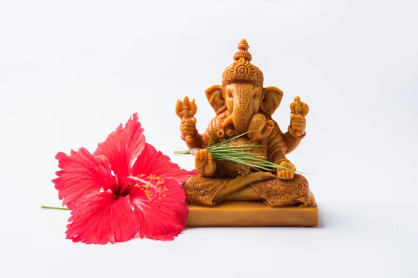 Happy Ganesh Chaturthi Greeting Card showing photograph of lord ganesha idol, pooja or puja thali, bundi laddu/modak, durva and hibiscus or jasvand flower — Stock Photo, Image