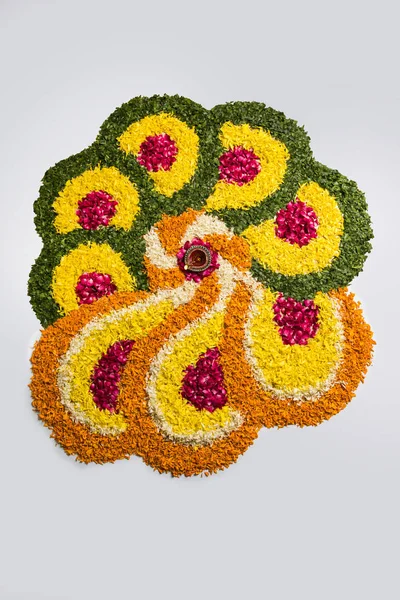 Gama de flores para Diwali o pongal o onam hechas con flores de caléndula o zendu y pétalos de rosa roja sobre fondo blanco con diwali diya en el centro, enfoque selectivo —  Fotos de Stock