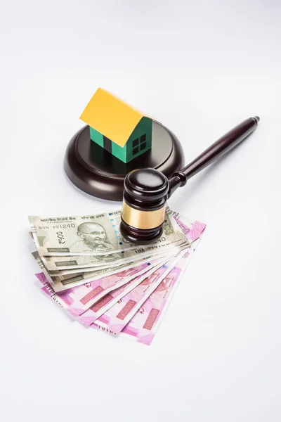stock photo of india and real estate law, Indian law for real estate / construction company  / architects / builders or buyers showing small house model, gavel / hammer, indian currency notes