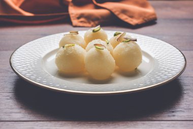 Stock Photo of Rasgulla or sponge Ras Gulla, It is made from ball shaped dumplings of chhena and semolina dough, cooked in light syrup made of sugar. clipart