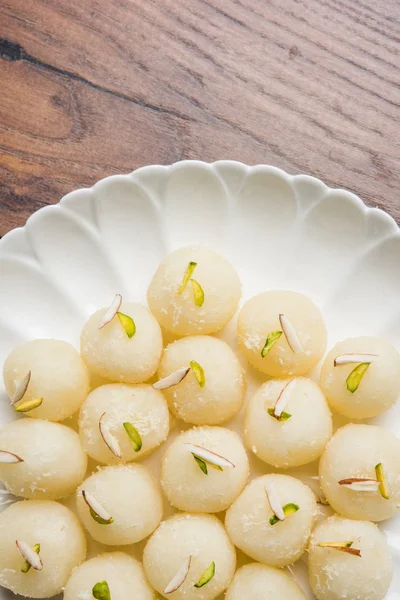 Stock Photo of Rasgulla or sponge Ras Gulla, It is made from ball shaped dumplings of chhena and semolina dough, cooked in light syrup made of sugar. — Stock Photo, Image