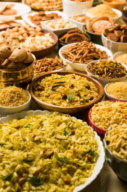 stock photo of  Diwali food or Diwali snacks or Diwali sweets like anarsa, bakarvadi, chakli, sev, bhujiya, shankar pale and chivda or chiwada, karanji, favourite indian diwali recipe, selective focus clipart