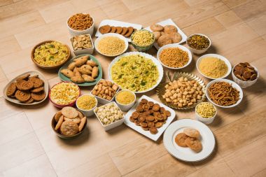 stock photo of  Diwali food or Diwali snacks or Diwali sweets like anarsa, bakarvadi, chakli, sev, bhujiya, shankar pale and chivda or chiwada, karanji, favourite indian diwali recipe, selective focus clipart