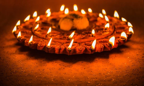 Stok fotoğraf bir ışıklı kiremit Diwali lamba veya Diya üzerine ayrıntılı sanat eseri ile. bir huysuz arka plan ve seçici odak