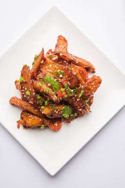 Tatlım kırmızı biber patates veya patates dilimleri, popüler Hint-Çin başlangıç tarifi, susam ve soğan ile süslenmiş. seçici odak