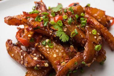 Tatlım kırmızı biber patates veya patates dilimleri, popüler Hint-Çin başlangıç tarifi, susam ve soğan ile süslenmiş. seçici odak