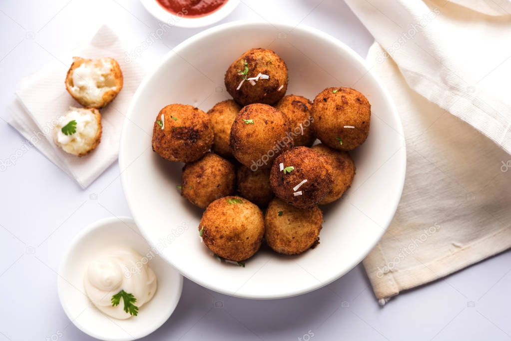 Fried potato cheese balls or croquettes with tomato ketchup. Selective focus