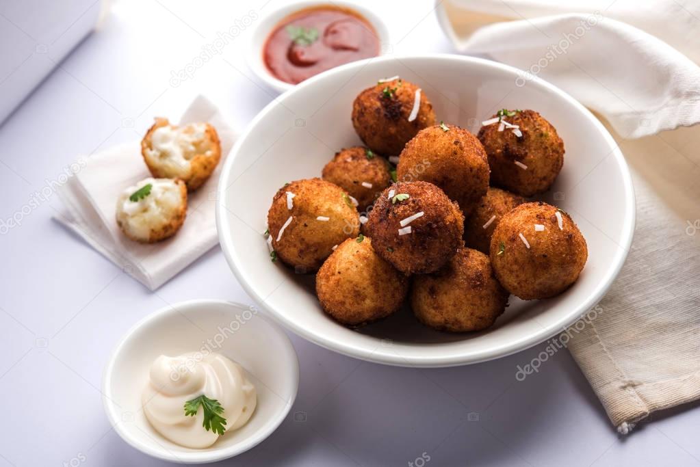 Fried potato cheese balls or croquettes with tomato ketchup. Selective focus