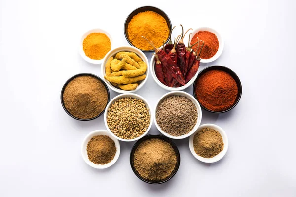 Indian colourful spices. Group photo of four basic Indian spices like raw red chilli, turmeric, coriander and cumin powder. selective focus
