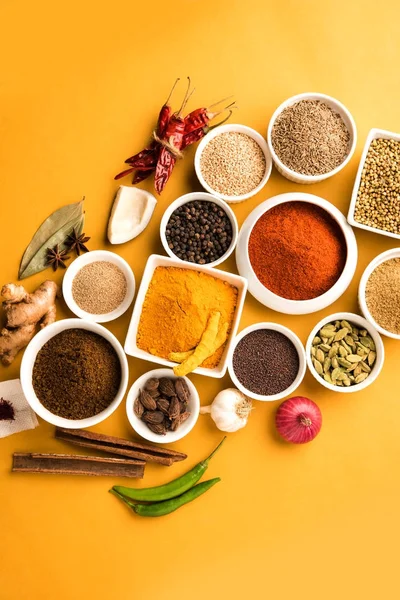 Raw Indian Spice Powder over red, yellow or green background, selective focus