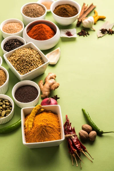 Raw Indian Spice Powder over red, yellow or green background, selective focus