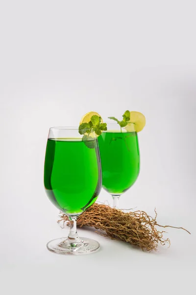 stock image Green KHUS Sharbat or Vetiver grass extract or Chrysopogon zizanioides served in tall glass with mint leaf, popular summertime refreshing drink from India