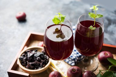 Kokum Sharbat, meyve suyu veya şerbet veya yaz soğutucu içecek Garcinia indica nane yaprağı ile bir bardakta servis ham meyve ile yapılmış. seçici odak