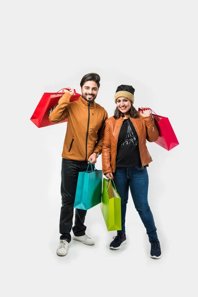 Indian Couple Shopping Bags Winter Warm Clothes White Background — Stock Photo, Image