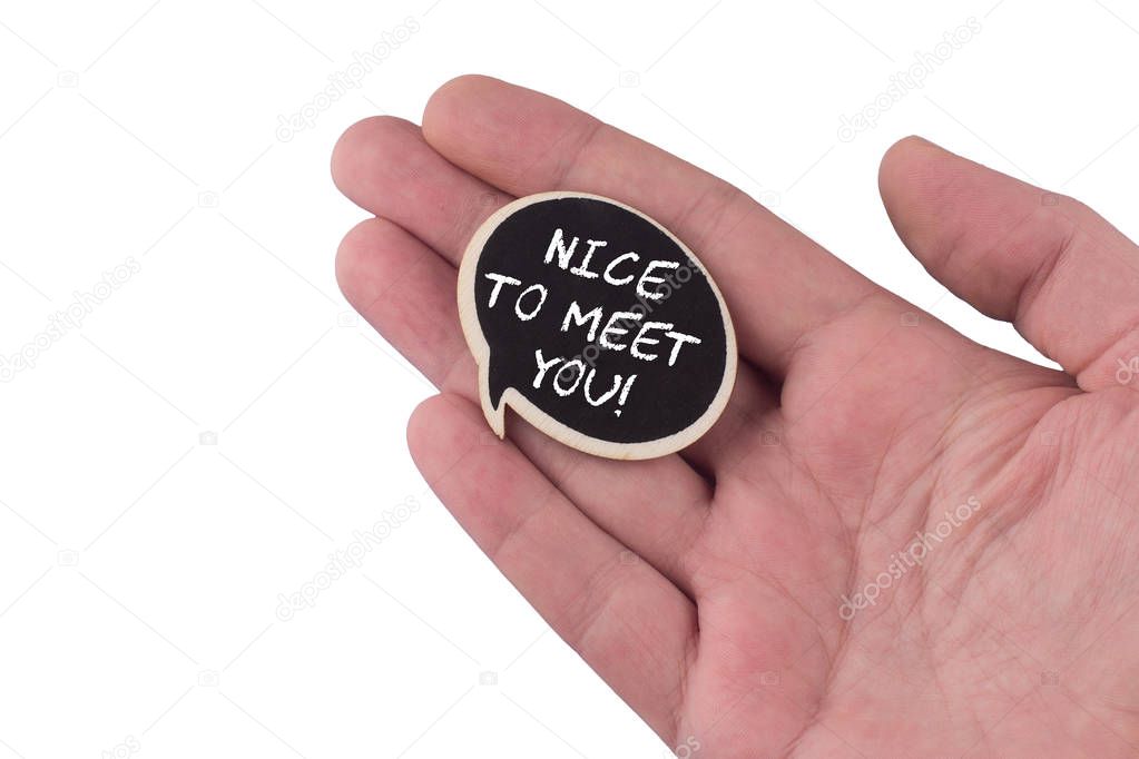 hand holding a wooden speech bubble with nice to meet you text o