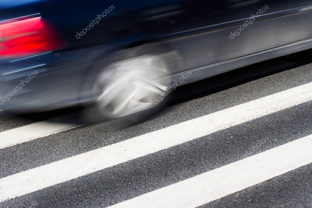 Black car with motion blur on street