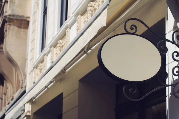 round empty signboard on a building with classical architecture