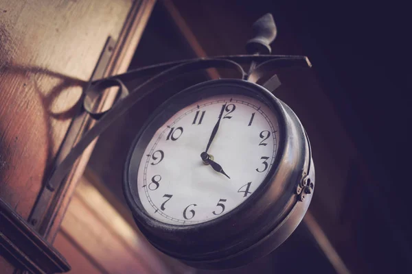 Vintage clock on a wooden wall — Stock Photo, Image