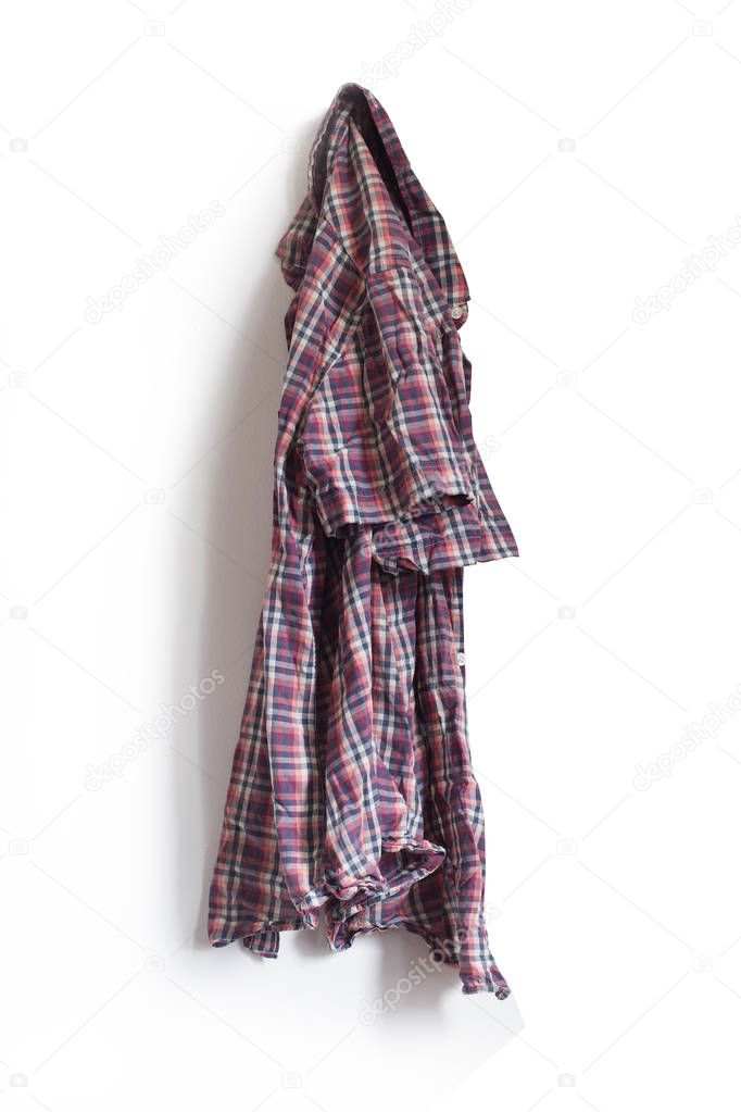 checkered shirt hanging on a white wall