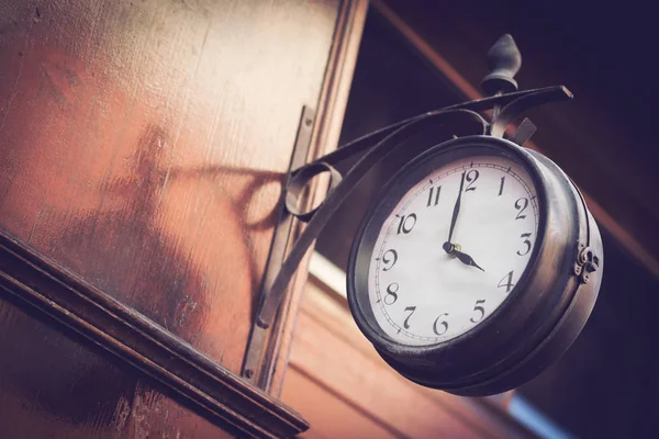 Vintage clock on a wooden wall — Stock Photo, Image