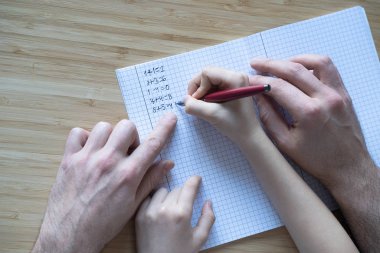 father and son or daughter doing the homework together