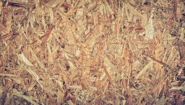 Hafif kahverengi ahşap panel arka plan, sorunsuz odaklı strand board - Osb ahşap dokusuna preslenmiş yakın çekim.