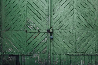 Eski ahşap yeşil kapı. Bir elmas şeklinde desen. Dokulu vintage.