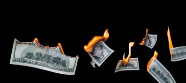 Birkaç yüz dolarlık banknot, düşüyor, siyah arka planda yanıyor. İflas, değer kaybı, değer kaybı, israf ve para israfı kavramı. Boşluğu kopyala, izole.