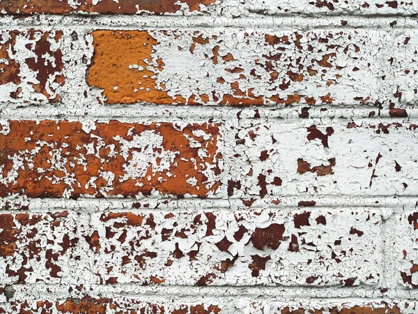 Old texture cracked red brick wall, the old white and white paint texture is chipping and cracked fall destruction. Grunge wall texture for design. Cracked color background.