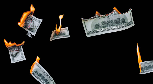 Several 100 dollar bills, falling down, burn on a black background. The concept of bankruptcy, depreciation, devaluation, wastefulness and waste of money. Copy space, isolated.