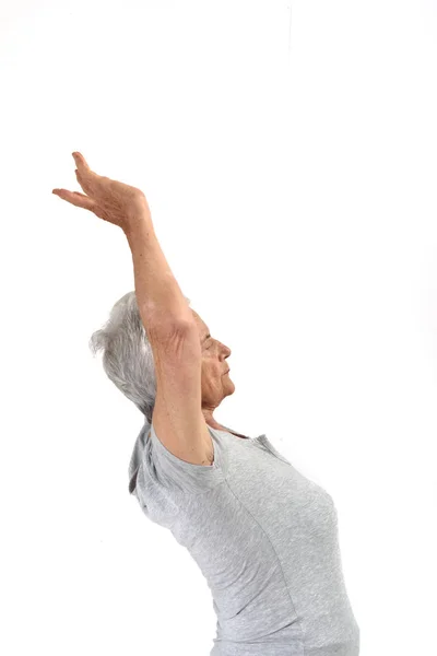 Oudere vrouw meditatie op wit — Stockfoto