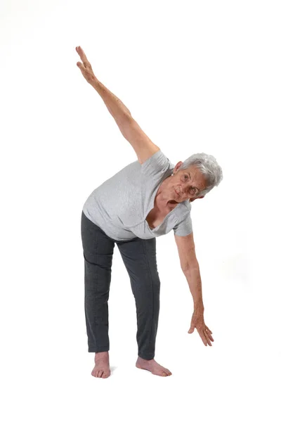 Femme plus âgée exerçant yoga isolé sur blanc — Photo