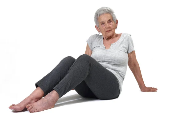 Older woman exercising exercising yoga isolated on white — Stock Photo, Image