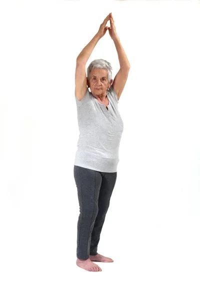 Older woman doing exercises on white Stock Image