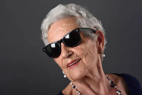 Retrato de uma mulher idosa com óculos — Fotografia de Stock
