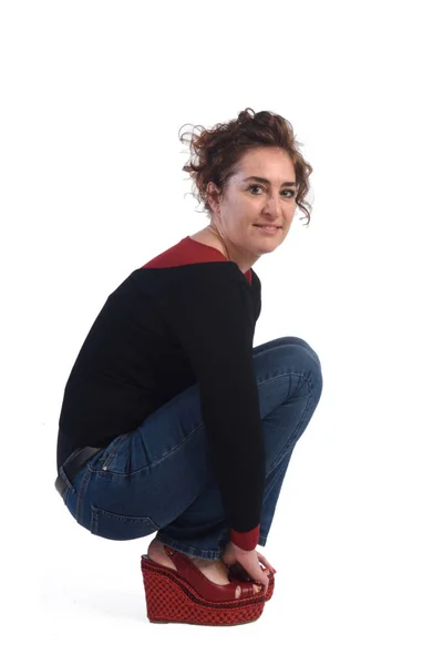 Woman crouching on a white background — Stock Photo, Image
