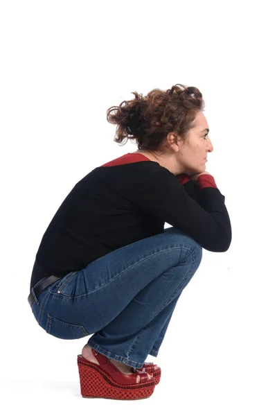 Woman crouching on a white background Royalty Free Stock Images